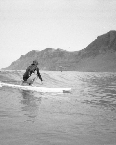 Gabby surfing small waves at Famara beach